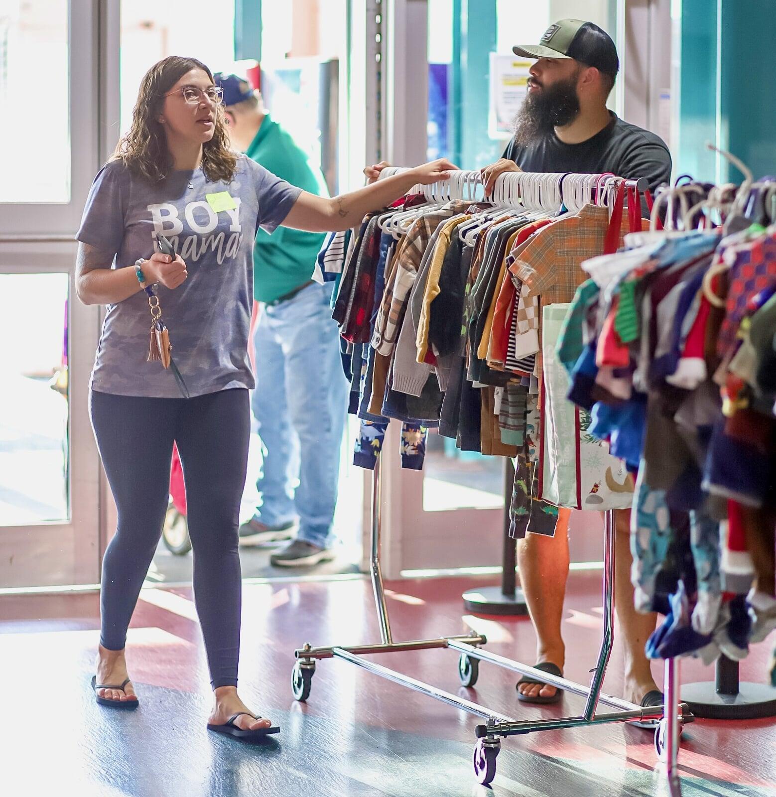 A rolling rack of clothing and other baby/children items in bins being wheeled into the JBF sale at Body Zone in Wyomissing, PA.