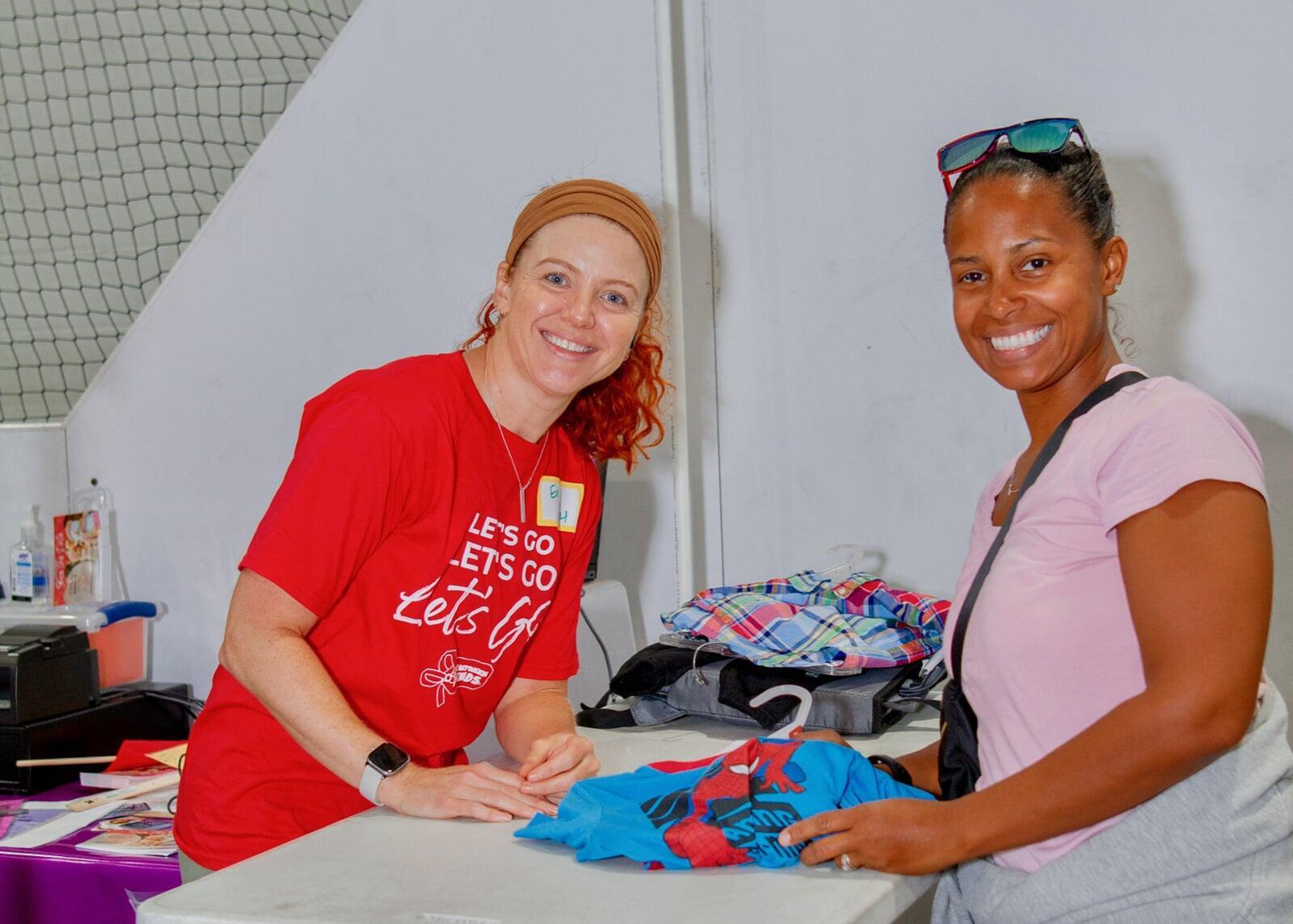 A JBF Team Member scanning clothing at the register.