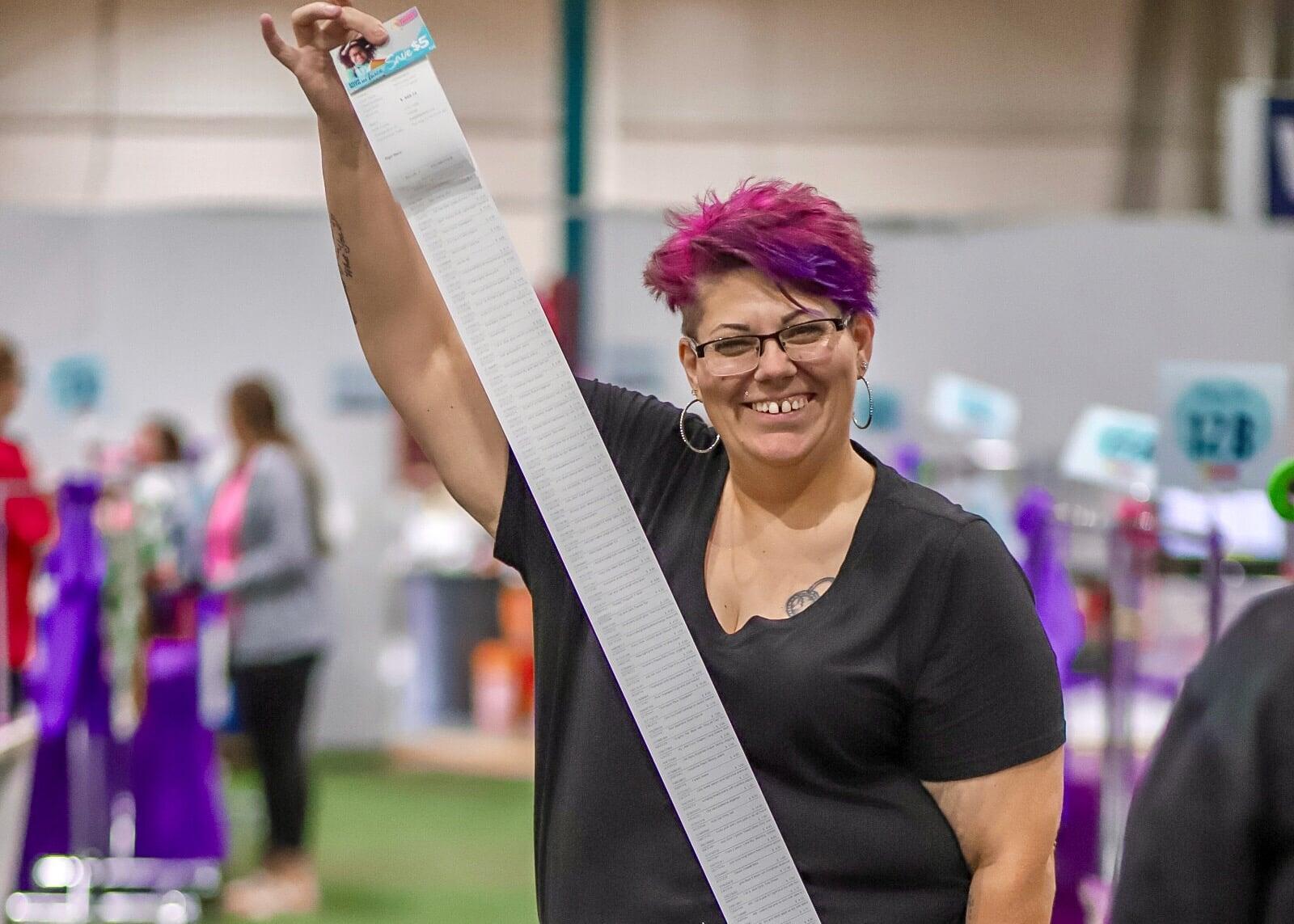 A JBF Manager smiles in between checking consignors in to drop off their items.