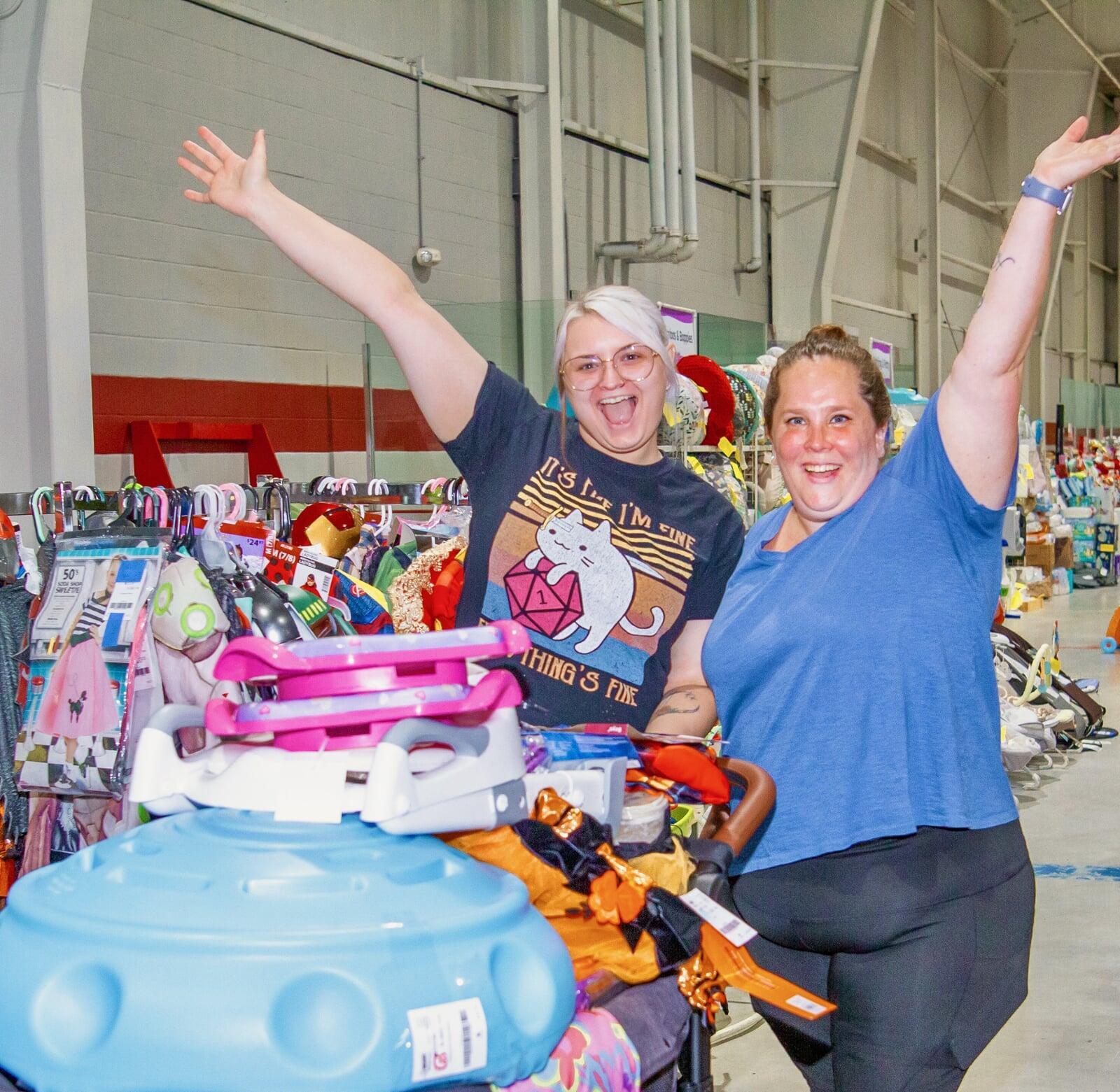 Two JBF team members helping a customer with an item
