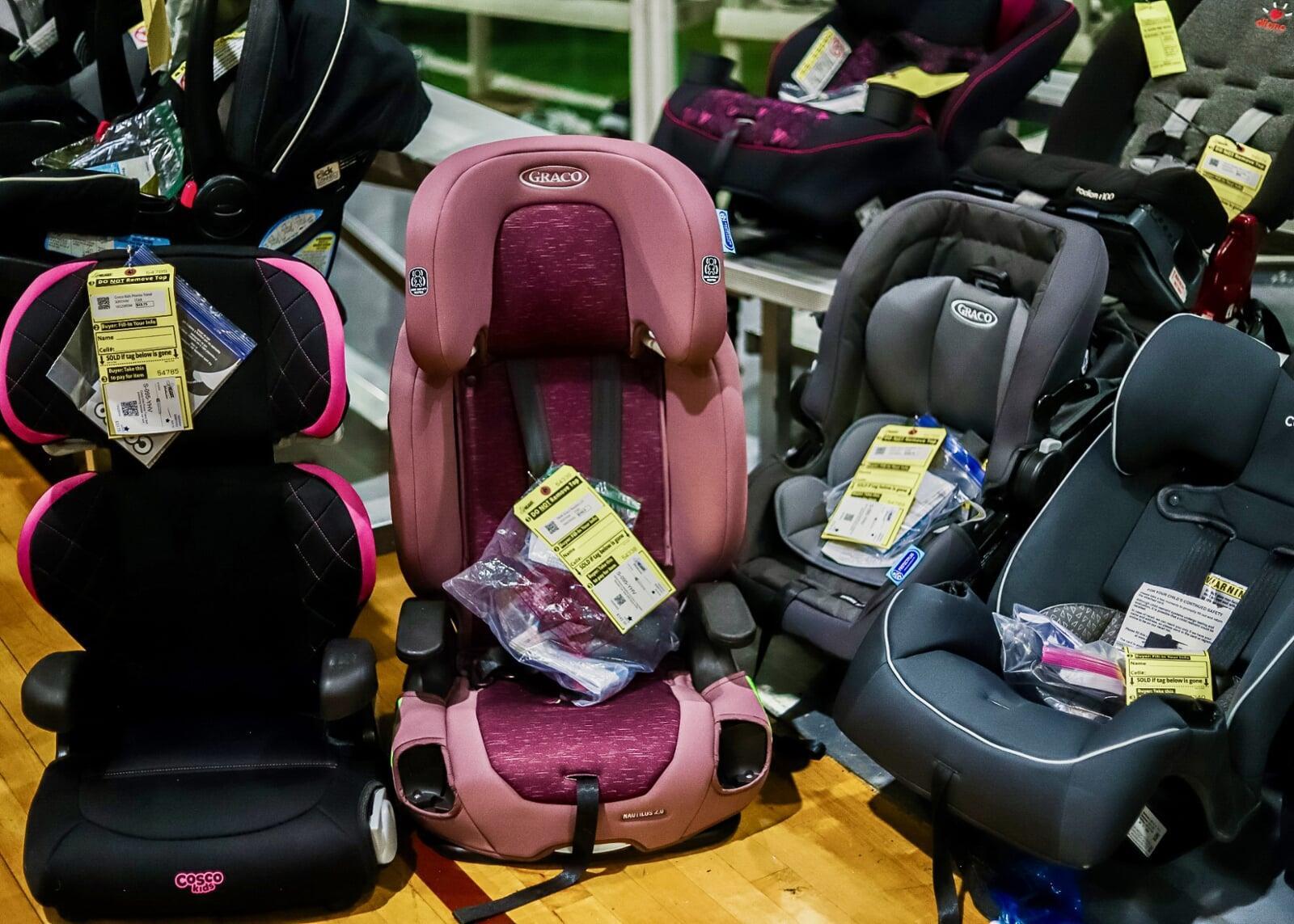 2 pink carseats on a table.