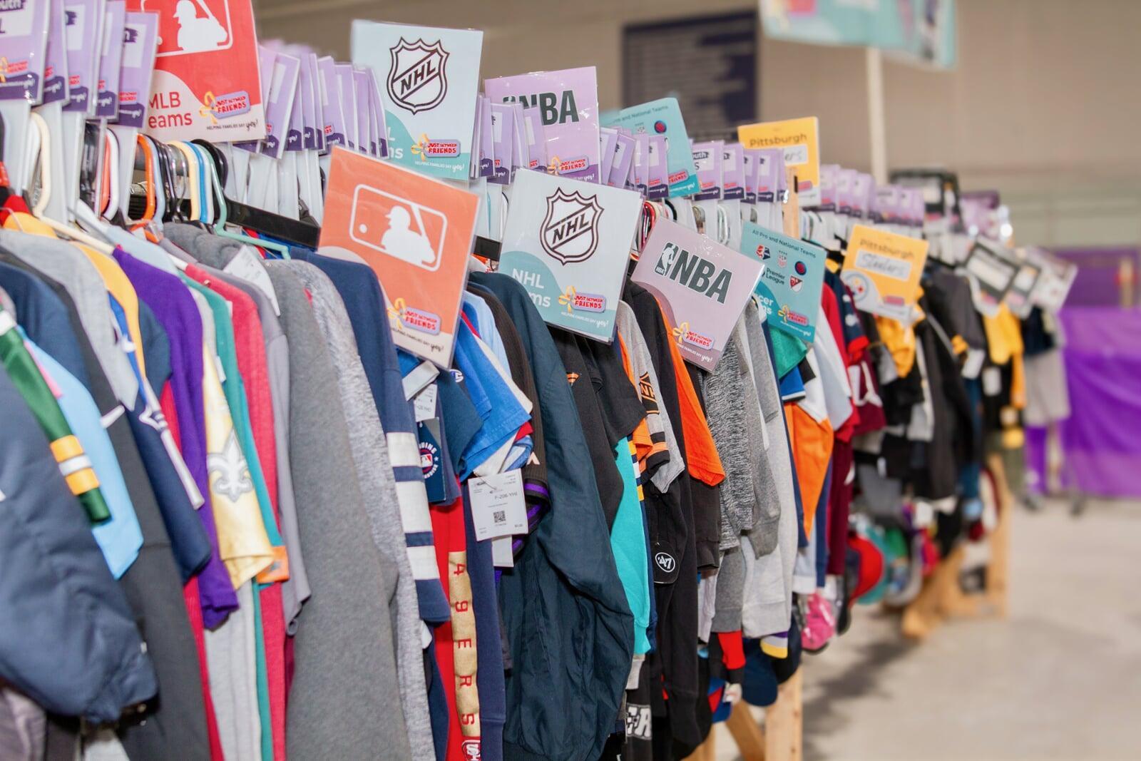 Variety of local PA sports teams fan gear from the NHL MLB NBA and NFL hang on a clothing rack